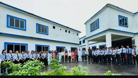 Students in uniform standing outside Barefooter School campus building